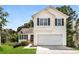 Two-story house with attached garage and front yard at 6635 Shapiro Ct, Stone Mountain, GA 30087