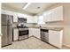 Updated kitchen featuring stainless steel appliances and granite countertops at 6635 Shapiro Ct, Stone Mountain, GA 30087
