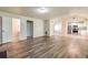 Open living room with kitchen view, hardwood floors, and neutral paint at 6635 Shapiro Ct, Stone Mountain, GA 30087