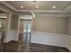 Elegant dining room featuring hardwood floors, wainscoting, and access to the backyard at 2900 Brandford Trl, Locust Grove, GA 30248