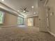 Large main bedroom with carpet flooring and access to the en-suite bathroom at 2900 Brandford Trl, Locust Grove, GA 30248