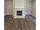 Modern fireplace with white mantel in a spacious room at 2900 Brandford Trl, Locust Grove, GA 30248