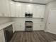 Modern kitchen featuring white cabinets, stainless steel appliances, and quartz countertops at 2900 Brandford Trl, Locust Grove, GA 30248