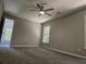 Bright bedroom featuring carpet, ceiling fan, and access to another room at 2900 Brandford Trl, Locust Grove, GA 30248