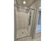 Walk-in shower with glass enclosure and tile surround at 2900 Brandford Trl, Locust Grove, GA 30248