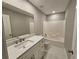 Clean bathroom with white vanity, quartz countertop, and a bathtub at 2900 Brandford Trl, Locust Grove, GA 30248