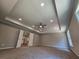 Spacious main bedroom with tray ceiling, ceiling fan, and carpet flooring at 2900 Brandford Trl, Locust Grove, GA 30248