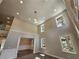Two-story foyer with high ceilings, chandelier, and hardwood floors at 2900 Brandford Trl, Locust Grove, GA 30248
