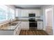 Updated kitchen with granite countertops, stainless steel appliances, and white cabinets at 2812 Mitchell Dr, Decatur, GA 30032
