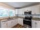 Renovated kitchen with white cabinets and granite counters at 2812 Mitchell Dr, Decatur, GA 30032