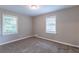 Well-lit bedroom with neutral carpeting and two windows at 2812 Mitchell Dr, Decatur, GA 30032
