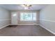 Spacious living room featuring neutral carpeting and a ceiling fan at 2812 Mitchell Dr, Decatur, GA 30032