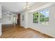 Bright dining room features hardwood floors, brick fireplace, and large window at 619 East Lake Rd, Mcdonough, GA 30252