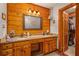 Double vanity bathroom with granite countertop and wooden cabinets at 3208 Paddock Rd, Covington, GA 30014