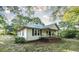 White house with a green metal roof and a porch at 2164 Five Points Rd, Waco, GA 30182