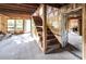 Unfinished basement with wooden stairs and exposed beams at 2164 Five Points Rd, Waco, GA 30182