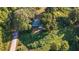 House nestled amongst lush green trees and a paved road at 2164 Five Points Rd, Waco, GA 30182