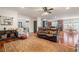 Open living room with hardwood floors, leather furniture, and kitchen view at 4068 Andover Cir, Mcdonough, GA 30252