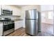 Kitchen with white cabinets, granite countertops, and stainless steel appliances at 416 Macedonia Se Rd, Atlanta, GA 30354