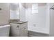 Clean bathroom with white tiled walls, granite countertop, and a bathtub at 416 Macedonia Se Rd, Atlanta, GA 30354