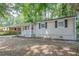 Light beige ranch house with dark gray shutters and small front yard at 416 Macedonia Se Rd, Atlanta, GA 30354