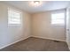 Well-lit bedroom with neutral walls, carpet, and two windows at 416 Macedonia Se Rd, Atlanta, GA 30354