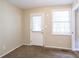 Bright bedroom featuring a window with blinds and an exterior door at 416 Macedonia Se Rd, Atlanta, GA 30354
