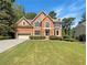 Two story brick house with attached garage and manicured lawn at 1965 Eagle Valley Ct, Lawrenceville, GA 30043