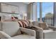 Luxury main bedroom with city views and comfortable armchairs at 1065 Peachtree Ne St # 3003, Atlanta, GA 30309