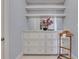 Bright walk-in closet with built-in shelving and drawers at 1065 Peachtree Ne St # 3003, Atlanta, GA 30309