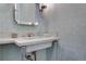 Stylish powder room featuring a pedestal sink and patterned wallpaper at 1065 Peachtree Ne St # 3003, Atlanta, GA 30309