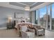 Spacious main bedroom with city views and sitting area at 1065 Peachtree Ne St # 3003, Atlanta, GA 30309