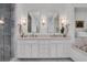 Elegant bathroom with double vanity, marble counters, and frameless shower at 1065 Peachtree Ne St # 3003, Atlanta, GA 30309