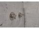 Close-up of shower fixtures with marble tile at 1065 Peachtree Ne St # 3003, Atlanta, GA 30309