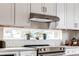 Modern kitchen with white cabinets, stainless steel appliances, and a window above the stove at 2029 Memorial Dr # 33, Atlanta, GA 30317