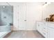 Bathroom with white cabinets, gray tile shower, and built-in seat at 2029 Memorial Dr # 33, Atlanta, GA 30317