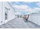 Spacious rooftop deck with gray tile flooring and wicker chairs at 2029 Memorial Dr # 33, Atlanta, GA 30317
