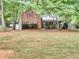 Brick house with red shutters, front porch, and large yard at 353 River Point Dr, Mcdonough, GA 30252