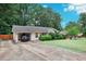 Ranch house with carport, landscaping and large yard at 2599 Creston Way, Morrow, GA 30260