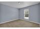Bright bedroom with neutral walls and carpeting at 4907 Wycliffe Sw Dr, Stone Mountain, GA 30087