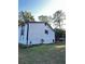Side view of the house, showcasing the white siding and newly painted black accents at 4907 Wycliffe Sw Dr, Stone Mountain, GA 30087