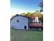 Side view of the house highlighting the white siding and newly painted black accents at 4907 Wycliffe Sw Dr, Stone Mountain, GA 30087