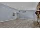 Spacious living room featuring hardwood floors, a stone fireplace, and large windows at 4907 Wycliffe Sw Dr, Stone Mountain, GA 30087