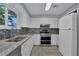 Updated kitchen with stainless steel appliances and granite countertops at 4907 Wycliffe Sw Dr, Stone Mountain, GA 30087