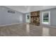 Living room with hardwood floors, stone fireplace, and large windows offering natural light at 4907 Wycliffe Sw Dr, Stone Mountain, GA 30087