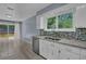 Bright kitchen with granite counters, stainless steel appliances, and deck access at 4907 Wycliffe Sw Dr, Stone Mountain, GA 30087
