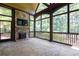 Spacious screened porch with stone flooring and a fireplace at 858 Middle Fork Trl, Suwanee, GA 30024