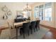Bright dining room with a large table and hardwood floors at 858 Middle Fork Trl, Suwanee, GA 30024