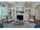Elegant living room featuring a fireplace and built-in shelving at 858 Middle Fork Trl, Suwanee, GA 30024
