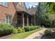 Brick home with a stone walkway leading to side porch at 858 Middle Fork Trl, Suwanee, GA 30024